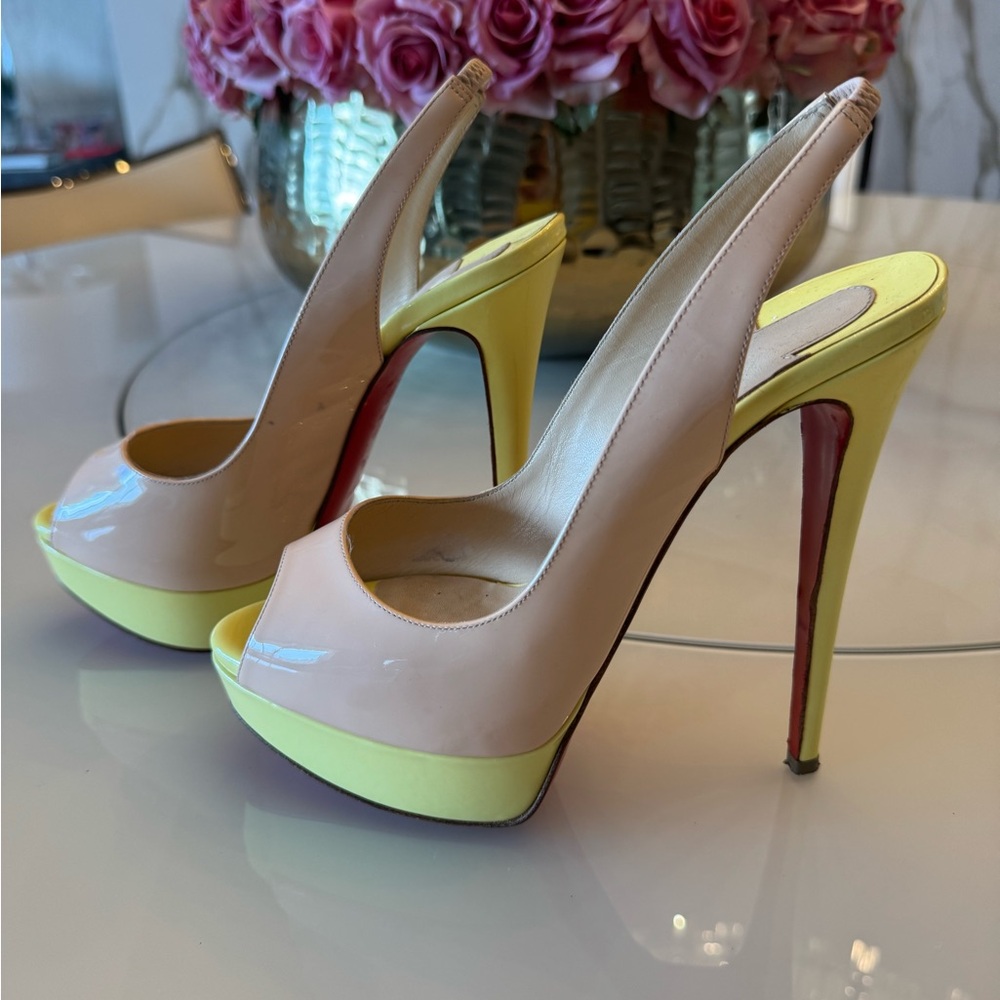 Christian louboutin Nude and Yellow Peep-Toe. 6” total
Heel
Including platform
